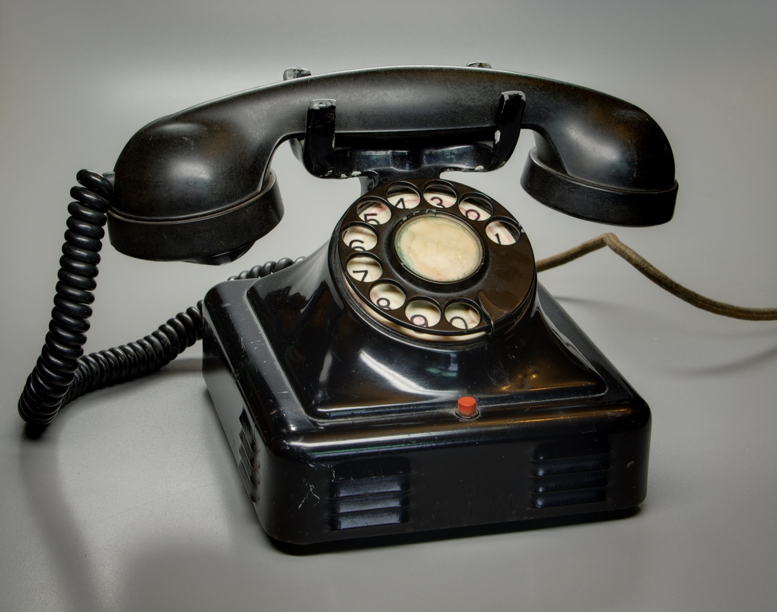 Black rotary dial telephone photographed from above